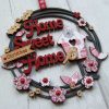 Home Sweet Home hanging sign with layered words, birdhouse and flowers.